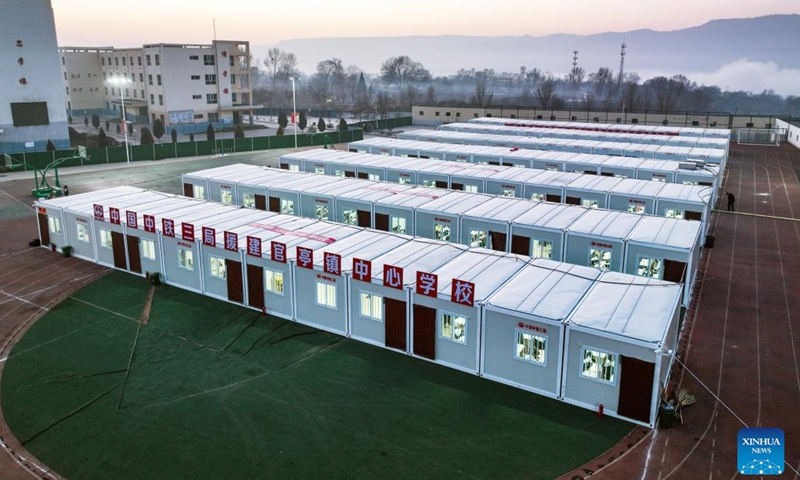 This aerial photo taken on Jan. 2, 2024 shows prefabricated classrooms on the playground at the central school in Guanting Township of Minhe Hui and Tu Autonomous County, Haidong City, northwest China's Qinghai Province. Quake-affected primary and secondary schools in Qinghai resumed offline classes on Tuesday. (Photo: Xinhua)