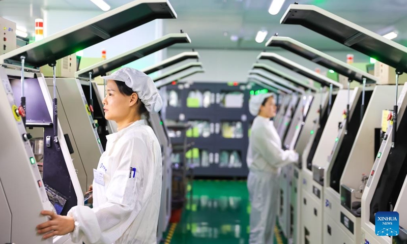 Workers are busy at a smart production line in a tech company in Ruichang City, east China's Jiangxi Province, Jan. 2, 2024. Workers around China have returned to their respective posts after the New Year holiday. (Photo: Xinhua)