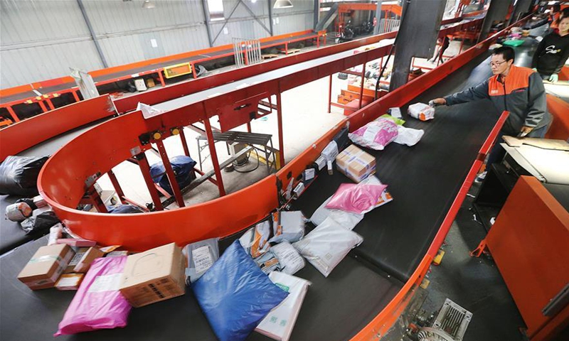 Employees work at the distribution center of a delivery company in Lianyungang, east China's Jiangsu Province. File Photo:Xinhua