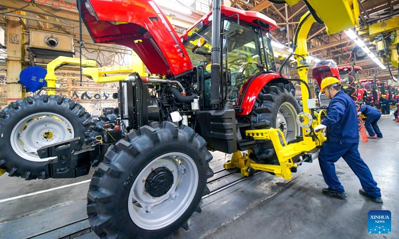 Workers assemble tractors in Luoyang, central China's Henan Province, Jan. 2, 2024. Workers around China have returned to their respective posts after the New Year holiday. (Photo: Xinhua)