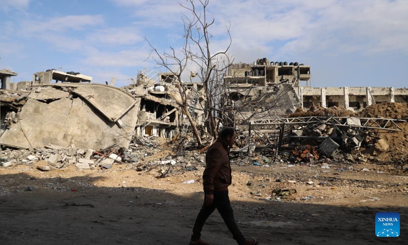 A man walks past destroyed buildings in Gaza City, on Jan. 2, 2024. The death toll of Palestinians has exceeded 22,000 after the outbreak of the Israel-Hamas conflict on Oct. 7, 2023, the Hamas-run Health Ministry said on Tuesday.(Photo: Xinhua)