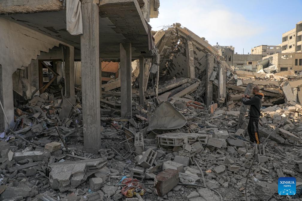 A man stands among the rubble of buildings destroyed in Israeli strikes in the southern Gaza Strip city of Khan Younis, on Jan. 4, 2024. Palestinian death toll from Israeli strikes on the Gaza Strip rose to 22,438 since the Israel-Hamas conflict broke out on Oct. 7, 2023, said the Gaza-based Health Ministry on Thursday.(Photo: Xinhua)