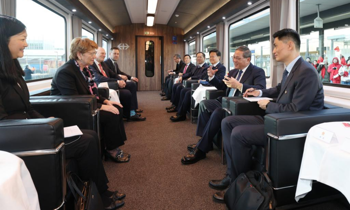 Chinese Premier Li Qiang engages in candid exchanges with President of the Swiss Confederation Viola Amherd in a relaxing and friendly atmosphere on a special train from Zurich to Bern, the capital of Switzerland, Jan. 14, 2024. (Xinhua/Wang Ye)