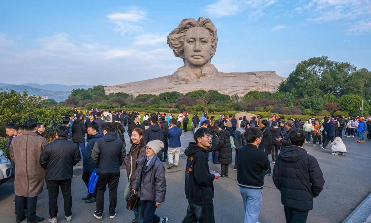 Tourists visit the Juzizhou scenic spot, where a stone statue of late Chinese leader Mao Zedong in his youth stands, in Changsha, Central China's Hunan Province on January 4, 2024. Photo: VCG