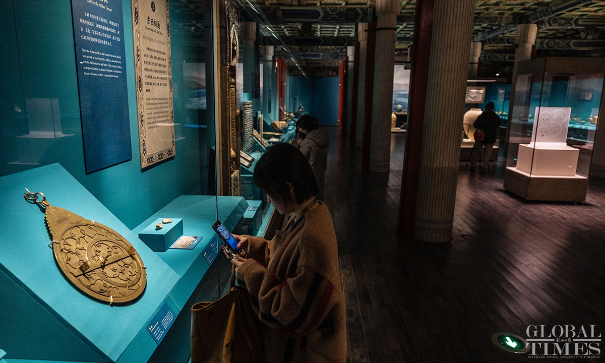 A visitor takes a photo of a precious relic at the exhibition in Beijing. Photo: Li Hao/GT