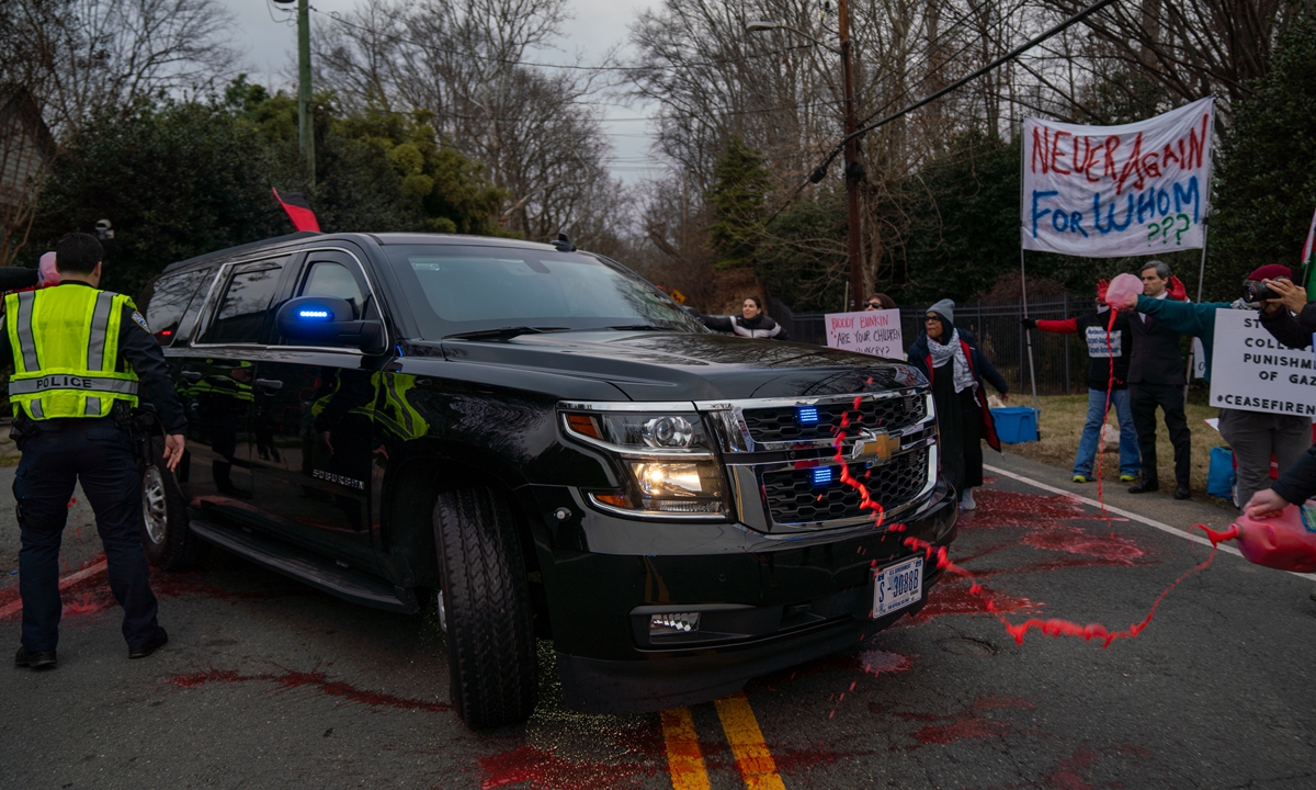 A group of pro-Palestine activists stage a protest in front of US Secretary of State Antony Blinken's house in McLean, Virginia, spilling fake blood on the streets and over his car as he leaves for work on January 4, 2024. Photo: VCG