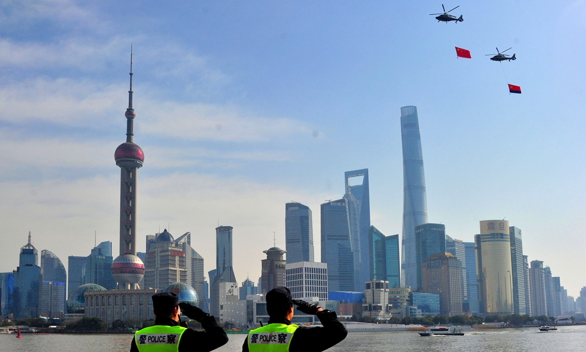 Two police officers salute to the Chinese national flag and the police flag hanging on helicopters in Shanghai on January 10, 2021. Activities were held that day to mark the first Chinese People's Police Day. Photo: VCG