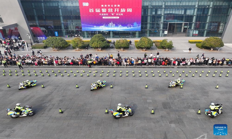 This aerial photo taken on Jan. 6, 2024 shows people watching a demonstration by traffic police officers during a police open week event in Nanjing, east China's Jiangsu Province.  (Xinhua/Li Bo)