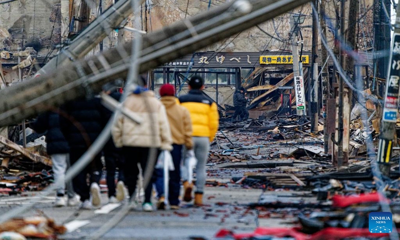 People check the ruins of the Wajima Morning Market which has been burned down by a large blaze following a series of earthquakes in Wajima city, Ishikawa prefecture, Japan, Jan. 4, 2024. (Xinhua/Zhang Xiaoyu)
