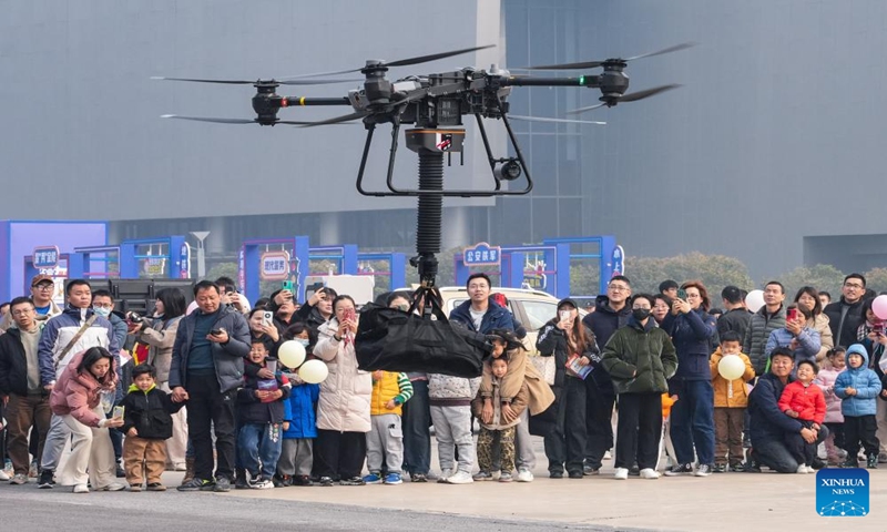People watch as a police drone demonstrates during a police open week event in Nanjing, east China's Jiangsu Province, Jan. 6, 2024. A five-day open week event organized by the Nanjing Municipal Public Security Bureau was initiated Saturday at Nanjing International Expo Center. With various online and offline activities, the open week aims to bring the public closer to the life and work of police officers. China will mark its fourth national police day on Jan. 10 this year.(Xinhua/Li Bo)