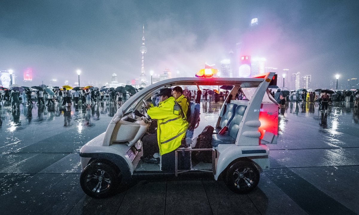 Police officers patrol on the Bund, also known as Waitan, in Shanghai on June 18, 2023. Photo: VCG