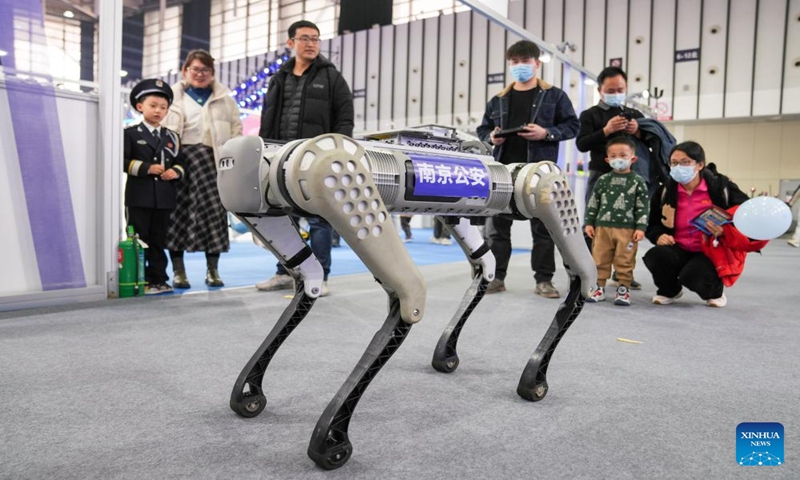 People look on as a robot police dog moves during a police open week event in Nanjing, east China's Jiangsu Province, Jan. 6, 2024. (Xinhua/Li Bo)