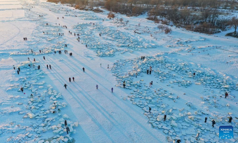 This aerial photo taken on Jan. 7, 2024 shows tourists having fun at an ice amusement spot on the Songhuajiang River Harbin section in Harbin, northeast China's Heilongjiang Province. Dubbed China's ice city, Harbin has recently seen a tourism boom. An ice amusement spot, transformed from an ice collecting site out of use, has attracted lots of visitors to have fun here with ice packs scattered on the Songhuajiang River Harbin section. (Xinhua/Xie Jianfei)
