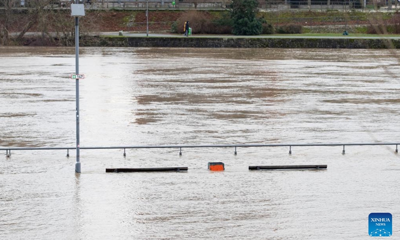 Benches along the Main River are submerged in flood water in Frankfurt, Germany, Jan. 7, 2024. Some areas in Frankfurt were flooded due to continuous rainfall and rising water level of the Main River. (Xinhua/Zhang Fan)
