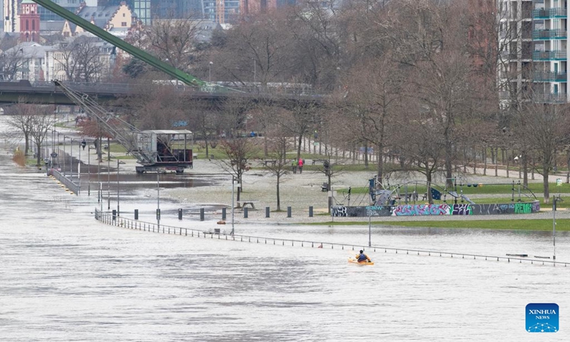 A man rows a kayak on the flooded river bank in Frankfurt, Germany, Jan. 7, 2024. Some areas in Frankfurt were flooded due to continuous rainfall and rising water level of the Main River. (Xinhua/Zhang Fan)