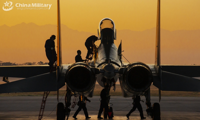 Ground crew assigned to an aviation brigade with the air force under the PLA Eastern Theater Command inspects a fighter jet during a flight training exercise. The training was conducted in early December to enhance the pilots' flight skills. Photo:China Military