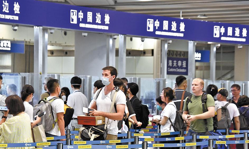 Tourists wait to pass through immigration at Beijing's Capital International Airport.File Photo:Xinhua
