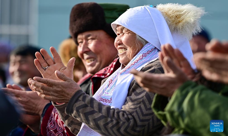 Herdsmen watch a performance in a service station in Emin County, northwest China's Xinjiang Uygur Autonomous Region, Jan. 11, 2024.
