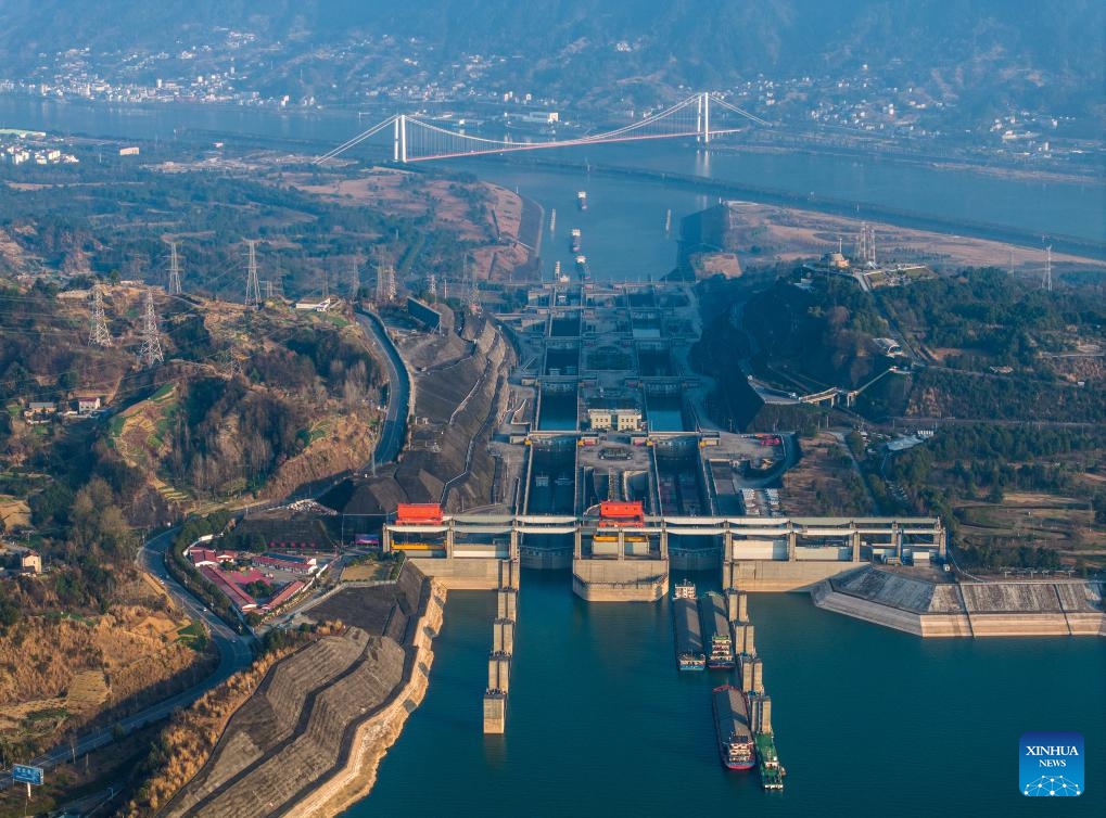 An aerial drone photo taken on Jan. 11, 2024 shows vessels passing through the five-tier ship locks of the Three Gorges Dam in Yichang, central China's Hubei Province. The cargo throughput via the Three Gorges Dam, the world's largest hydropower project on the upper stream of the Yangtze River, reached a record high of 172.34 million tonnes in 2023, up 7.95 percent year on year, according to the China Three Gorges Corporation.(Photo: Xinhua)