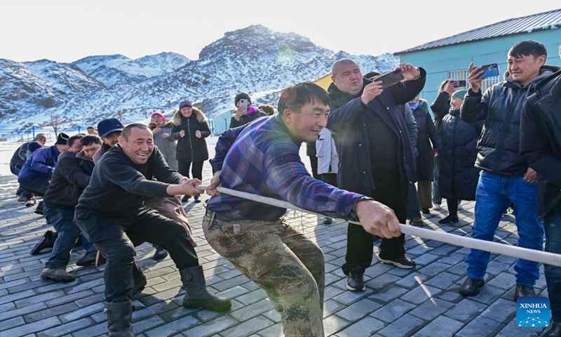 Herdsmen take part in a tug-of-war game in a service station in Emin County, northwest China's Xinjiang Uygur Autonomous Region, Jan. 11, 2024.