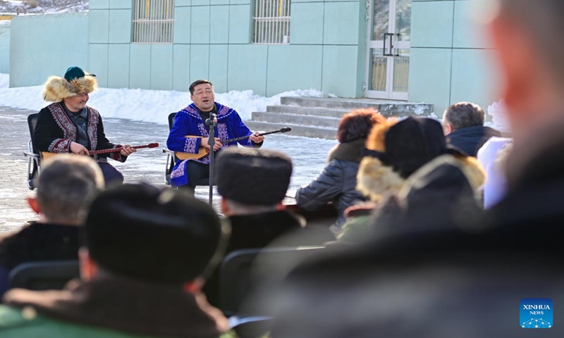 Herdsmen watch a performance in a service station in Emin County, northwest China's Xinjiang Uygur Autonomous Region, Jan. 11, 2024.