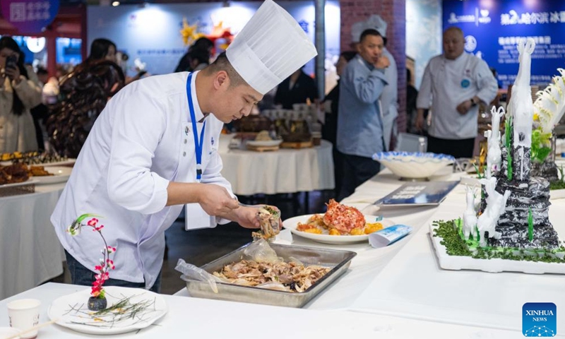 A chef cooks during a food festival in Harbin, northeast China's Heilongjiang Province, Jan. 20, 2024. (Xinhua/Xie Jianfei)