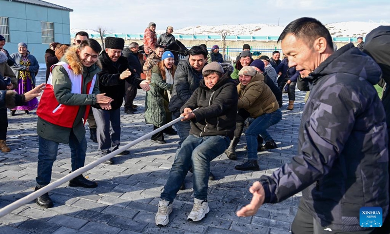 Herdsmen take part in a tug-of-war game in a service station in Emin County, northwest China's Xinjiang Uygur Autonomous Region, Jan. 11, 2024.