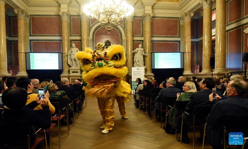 Performers perform a lion dance during an event, hosted by the Confucius Institute of the University of Vienna, in celebration of the upcoming Spring Festival in Vienna, Austria, on Jan. 12, 2024. (Xinhua/He Canling)