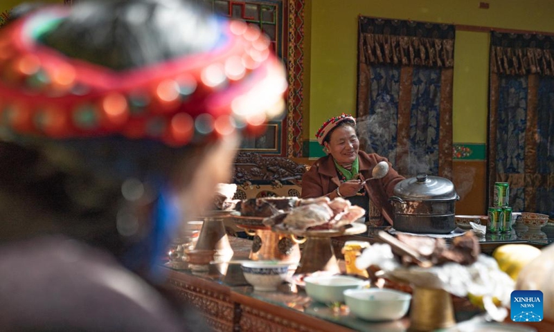 Pasang Butri prepares cereal porridge for her family members at home in Xigaze, southwest China's Xizang Autonomous Region, Jan. 12, 2024. Locals in Xigaze celebrate the farmers' New Year on the first day of the twelfth month of the Tibetan calendar, which fell on Jan. 12 this year.
