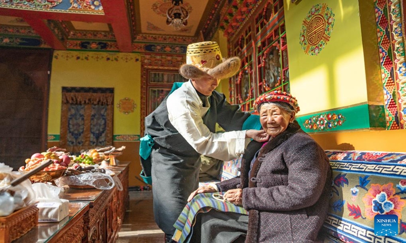 Pasang Butri's mother (R) is pictured during the celebration of the farmers' New Year at home in Xigaze, southwest China's Xizang Autonomous Region, Jan. 12, 2024. Locals in Xigaze celebrate the farmers' New Year on the first day of the twelfth month of the Tibetan calendar, which fell on Jan. 12 this year.