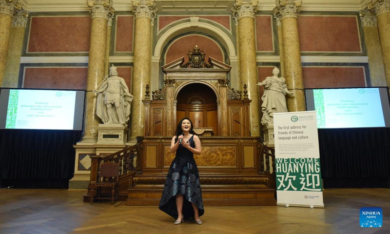 A performer sings a Chinese song during an event, hosted by the Confucius Institute of the University of Vienna, in celebration of the upcoming Spring Festival in Vienna, Austria, on Jan. 12, 2024. (Xinhua/He Canling)