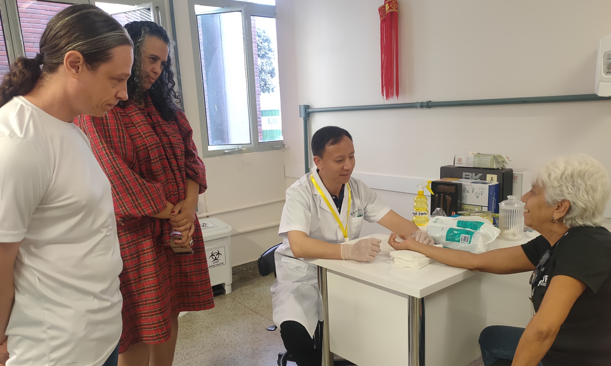 TCM doctor Zhang Xuanping (center) treats Brazilian patients during the HEBCM expert delegation's visit in October 28-November 10, 2023. Photo: Courtesy of HEBCM