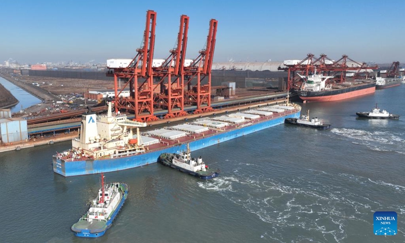 An aerial drone photo taken on Jan. 15, 2024 shows a ship docking at a coal terminal of Tangshan Port in north China's Hebei Province. In 2023, the cargo throughput at Tangshan Port surpassed 842.17 million tonnes, up 9.53 percent year on year, according to port authorities.(Photo: Xinhua)