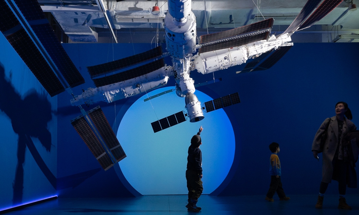A boy points at the model of the Tiangong space station at the art exhibition Infinity China Aerospace Photo: IC