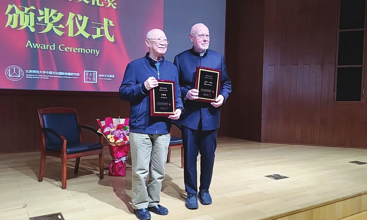 Luo Jinlin (left) and Marco Mueller are awarded at the 9th Huilin Prize at Beijing Normal University. Photo: Embassy of Greece in Beijing