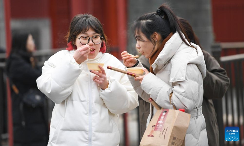 People eat Laba porridge at the Yonghegong Lama Temple in Beijing, capital of China, Jan. 18, 2024. The Laba Festival, literally the eighth day of the 12th lunar month, is considered a prelude to the Spring Festival, or Chinese Lunar New Year. It is customary to eat Laba porridge on this day.(Photo: Xinhua)