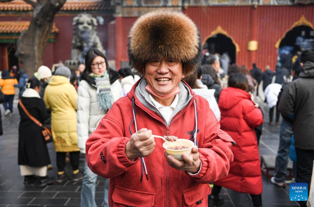 A citizen shows a bowl of Laba porridge at the Yonghegong Lama Temple in Beijing, capital of China, Jan. 18, 2024. The Laba Festival, literally the eighth day of the 12th lunar month, is considered a prelude to the Spring Festival, or Chinese Lunar New Year. It is customary to eat Laba porridge on this day.(Photo: Xinhua)