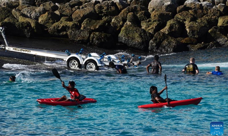 People enjoy leisure time in a bay in the Republic of Nauru, Jan. 18, 2024.(Photo: Xinhua)