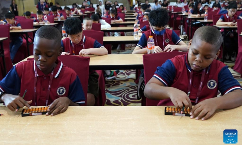Contestants warm up before the Third Indonesia Shenmo Cup International Abacus Mental Arithmetic Competition in Bandung, West Java, Indonesia, Jan. 20, 2024. The event kicked off on Saturday with nearly 200 children competing in this year's competition. (Xinhua/Ma Ning)