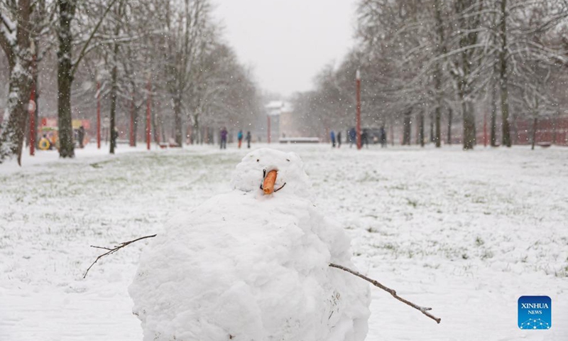 A snowman is seen amid snowfall in Lille, northern France, Jan. 17, 2024. (Photo by Sebastien Courdji/Xinhua)