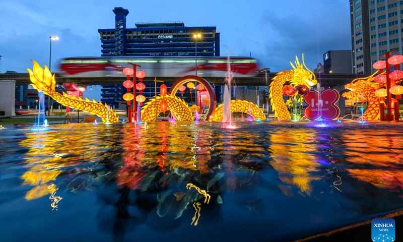This photo taken on Jan. 19, 2024 shows dragon-shaped light installations in celebration of the upcoming Chinese zodiac Year of the Dragon outside a shopping mall in Kuala Lumpur, Malaysia. (Photo by Chong Voon Chung/Xinhua)
