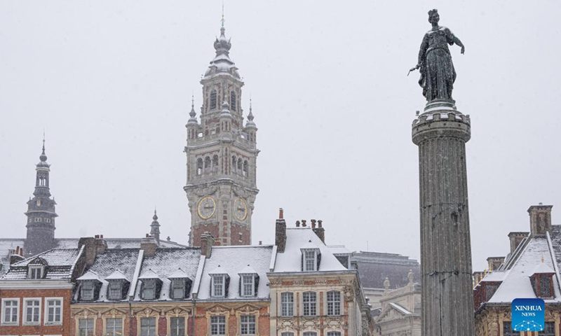 This photo taken on Jan. 17, 2024 shows a city view amid snowfall in Lille, northern France. (Photo by Sebastien Courdji/Xinhua)