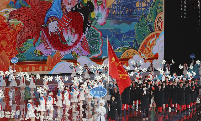 The delegation of Tianjin parade into the stadium during the opening ceremony of the China's 14th National Winter Games in Hulun Buir, north China's Inner Mongolia Autonomous Region, Feb. 17, 2024. (Xinhua/Jiang Fan)