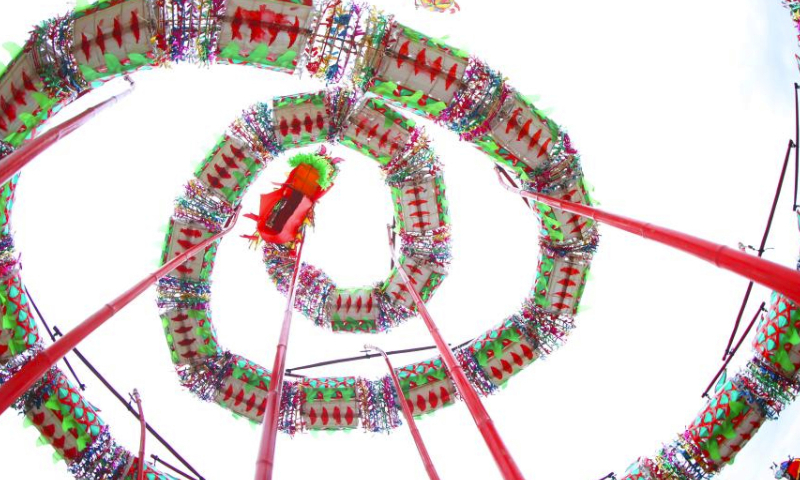 People perform dragon dance at Nanyue Town of Hengyang, central China's Hunan Province, Feb. 24, 2024. People across the country celebrated the Lantern Festival on Saturday amid a festive and bustling atmosphere. (Photo by Cao Zhengping/Xinhua)