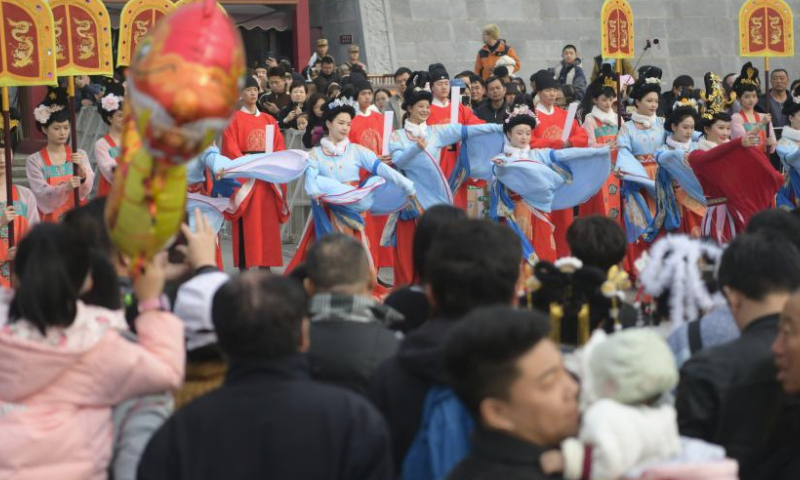 People watch a performance in front of the Yingtianmen site museum of the National Archaeological Site Park of Sui-Tang Luoyang City in Luoyang City, central China's Henan Province, Feb. 14, 2024. During the Spring Festival holiday, various cultural tourism events across central China's Henan Province have attracted lots of tourists. (Photo by Zhang Yixi/Xinhua)