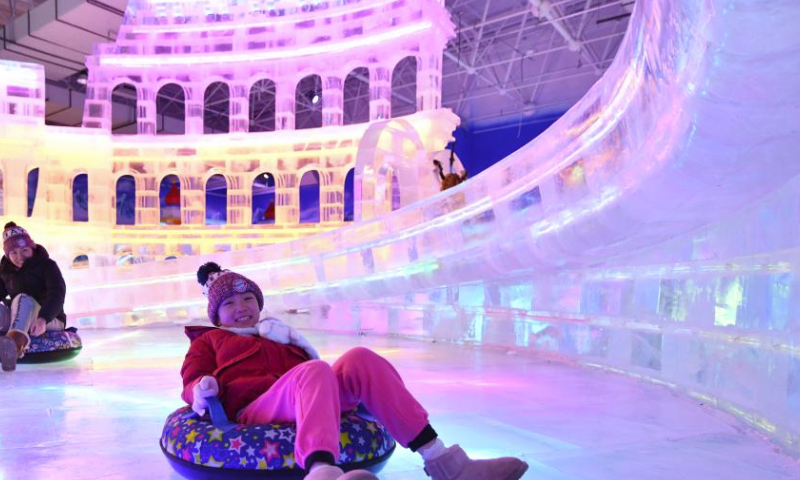 Tourists have fun at an ice and snow art gallery of the Sun Island scenic spot in Harbin, northeast China's Heilongjiang Province, Feb. 23, 2024. Covering an area of nearly 5,000 square meters, this indoor ice and snow art gallery wowed tourists with ice sculptures and various ice and snow entertainment. (Xinhua/Wang Jianwei)