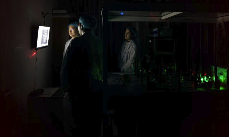 Researchers perform an experiment at a laboratory in the Shanghai Institute of Optics and Fine Mechanics, Chinese Academy of Sciences in east China's Shanghai, Feb. 29, 2024. (Xinhua/Jin Liwang)