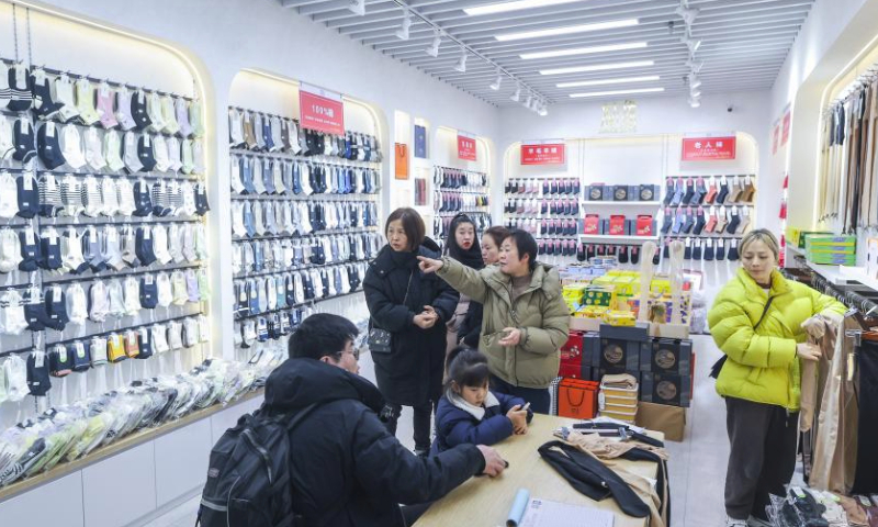 Customers buy socks at a shop at the Datang subdistrict in Zhuji, east China's Zhejiang Province, Feb. 24, 2024.

Production lines of sock companies in east China's Zhuji City, dubbed as the sock capital, are operating at full swing to meet the orders.

As the world's largest sock manufacturing base, the Datang sub-district of Zhuji in Zhejiang Province produces approximately 25 billion pairs of socks yearly, accounting for more than 70 percent of the output of China and one-third of the whole world. (Xinhua/Xu Yu)