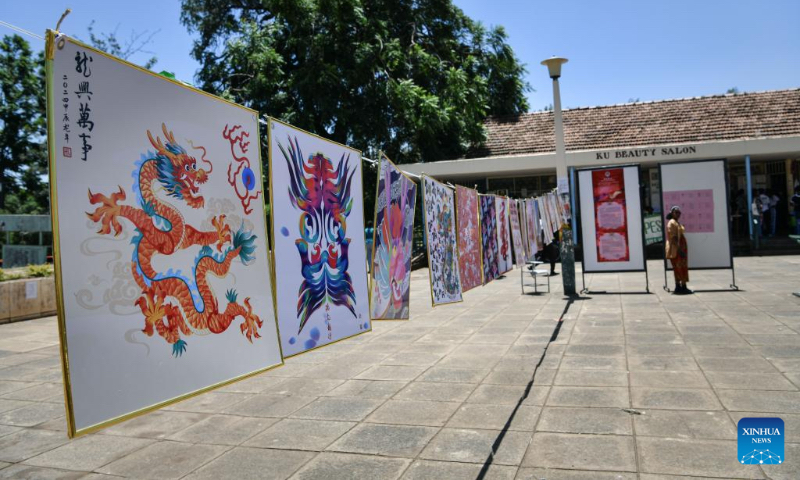 This photo shows artworks on display during the Dragon Design Exhibition held at Kenyatta University in Nairobi, Kenya, Feb. 15, 2024. The day-long event showcasing different aspects of the Chinese dragon was held Thursday at Kenyatta University, Kenya's second oldest public university. (Xinhua/Han Xu)