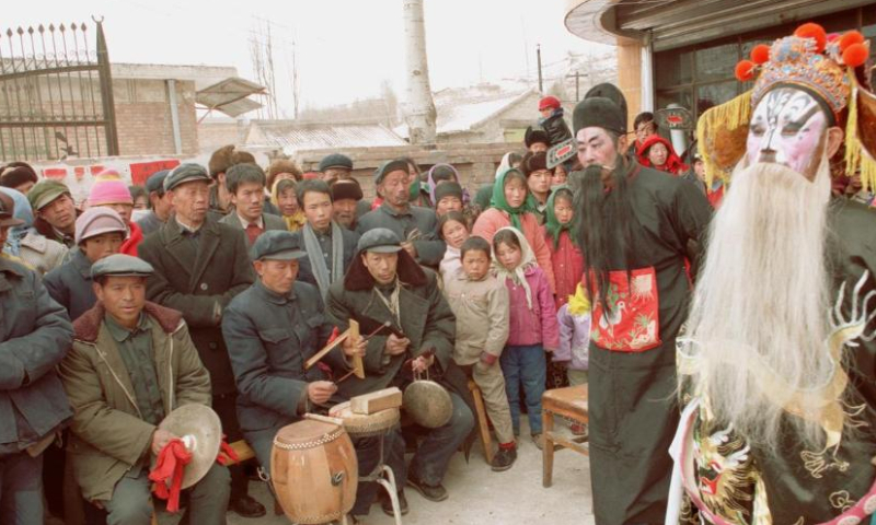 Actors of a Shehuo folk performance team perform Qinqiang opera in Shizilu Township, Guyuan County, northwest China's Ningxia Hui Autonomous Region during the Spring Festival in 1997.